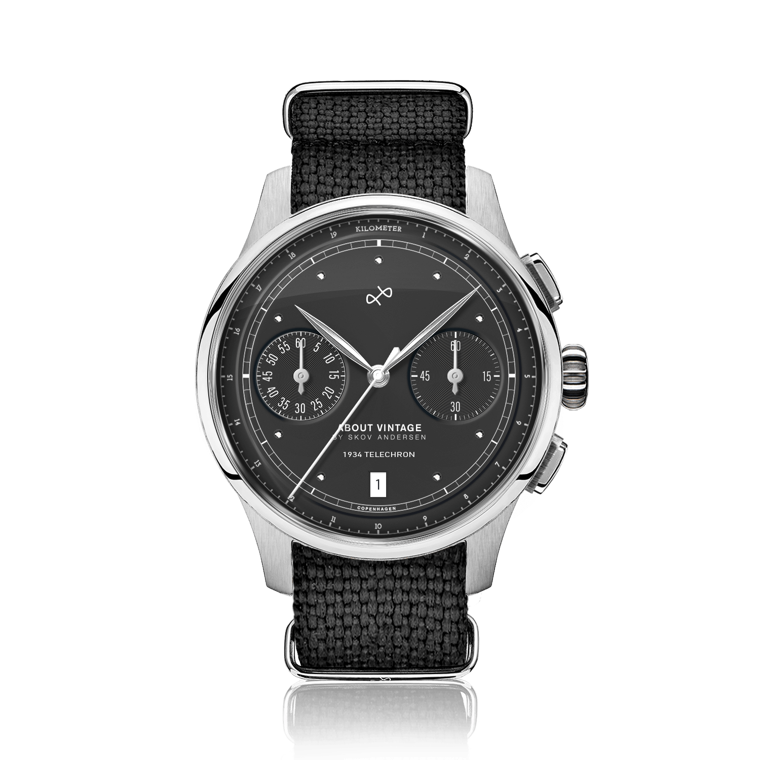 1934 Telechron, Steel / Black by AV86 features a vintage-inspired chronograph with a black dial, dual subdials, date window, sapphire crystal, polished steel case, and textured black fabric strap, exemplifying Danish horological precision and Nordic minimalism.