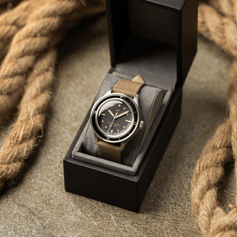 1956 Marine by AV86 vintage-inspired diver with acrylic bezel, luminous markers, domed crystal, and textured fabric strap