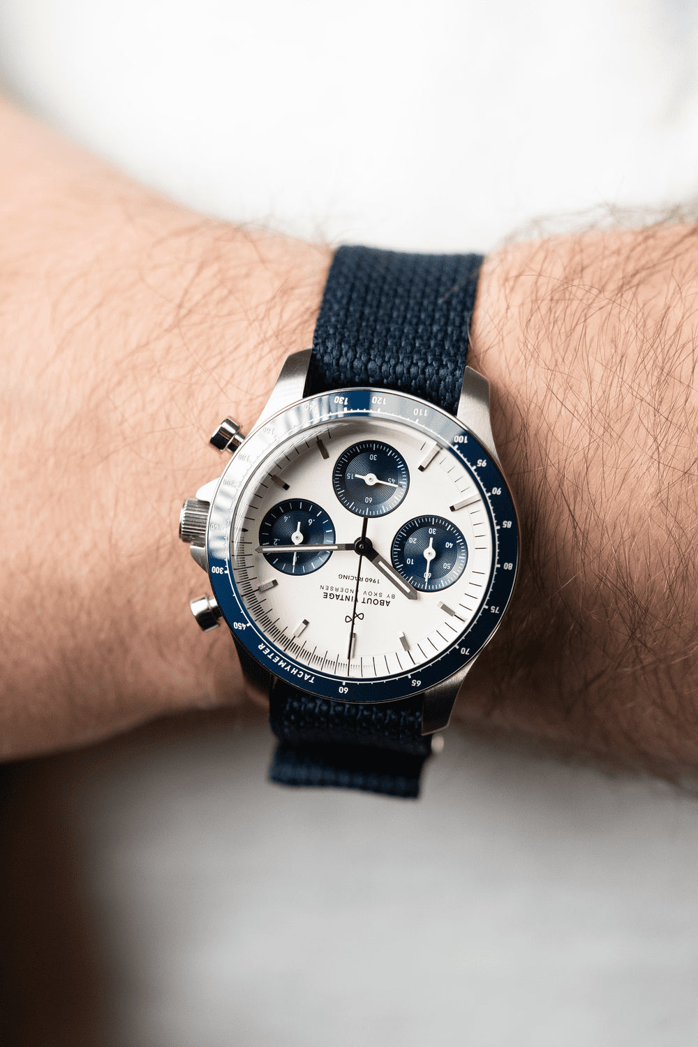 1960 Racing Chronograph by AV86 with vintage-inspired dial, sapphire crystal, tachymeter bezel, and navy fabric strap on wrist