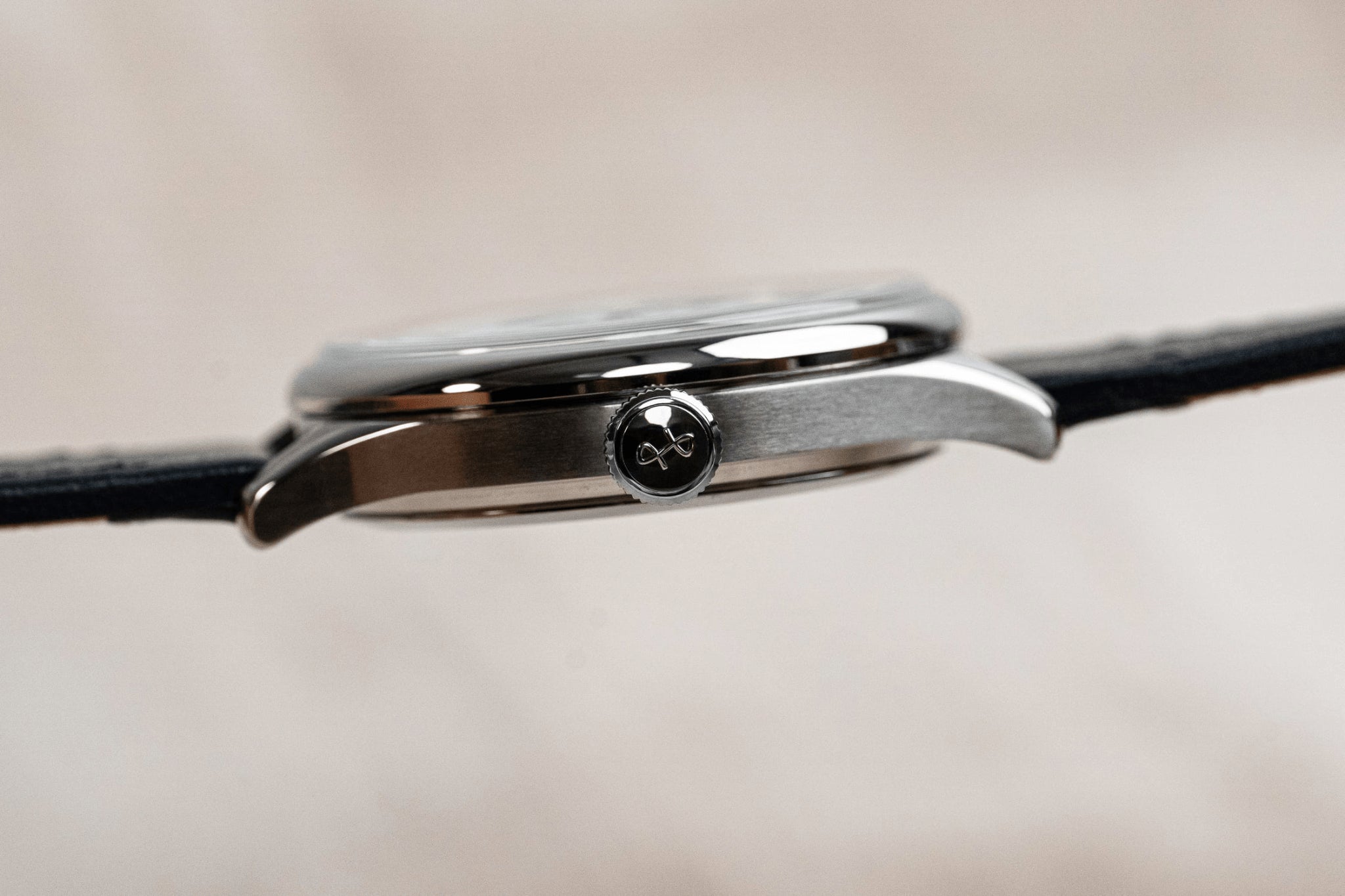 1968 Mechanical by AV86 slim mechanical watch with polished crown, sapphire crystal, and black leather strap close-up side view