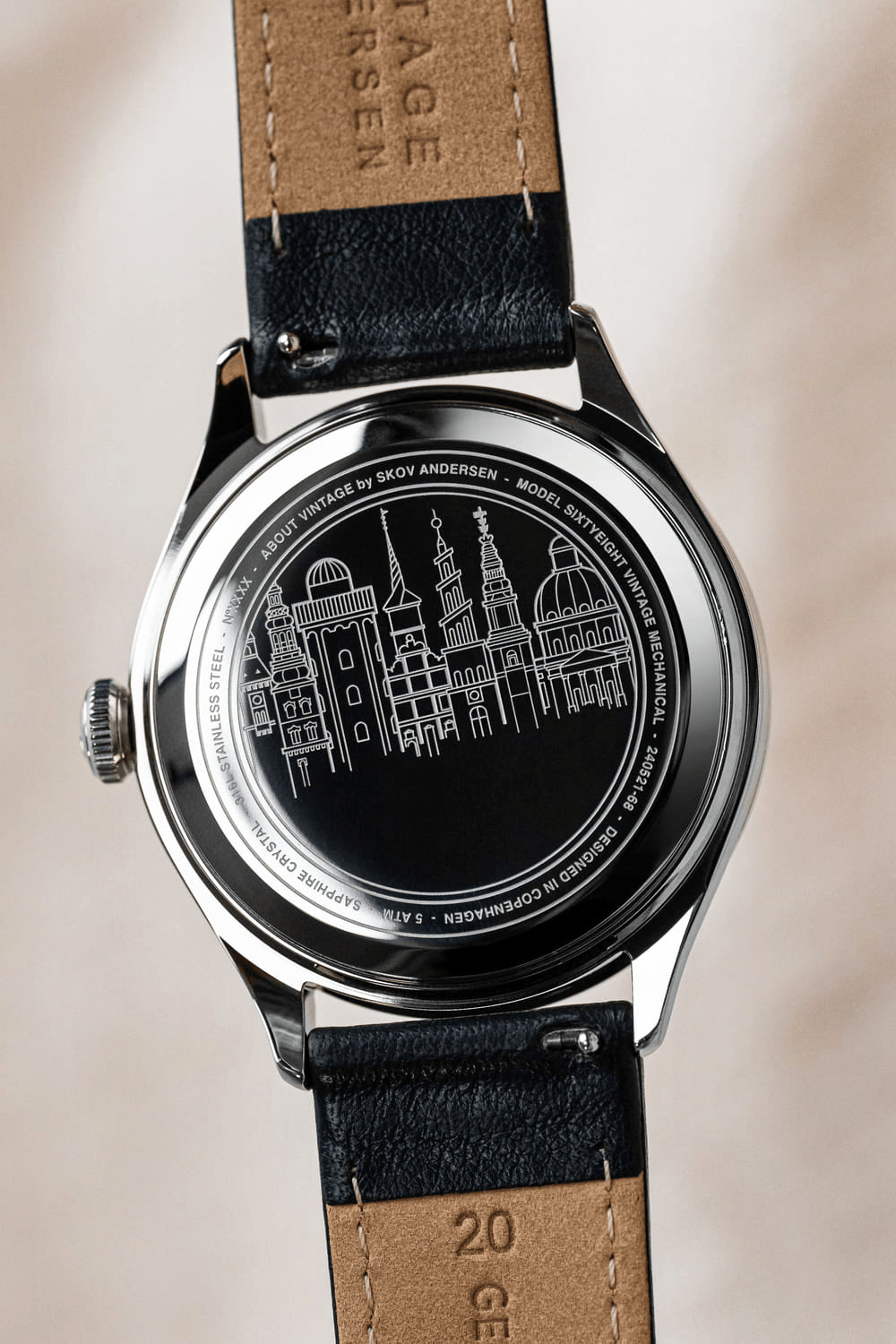 1968 Mechanical by AV86 showcasing stainless steel case back with Copenhagen skyline engraving and leather strap details