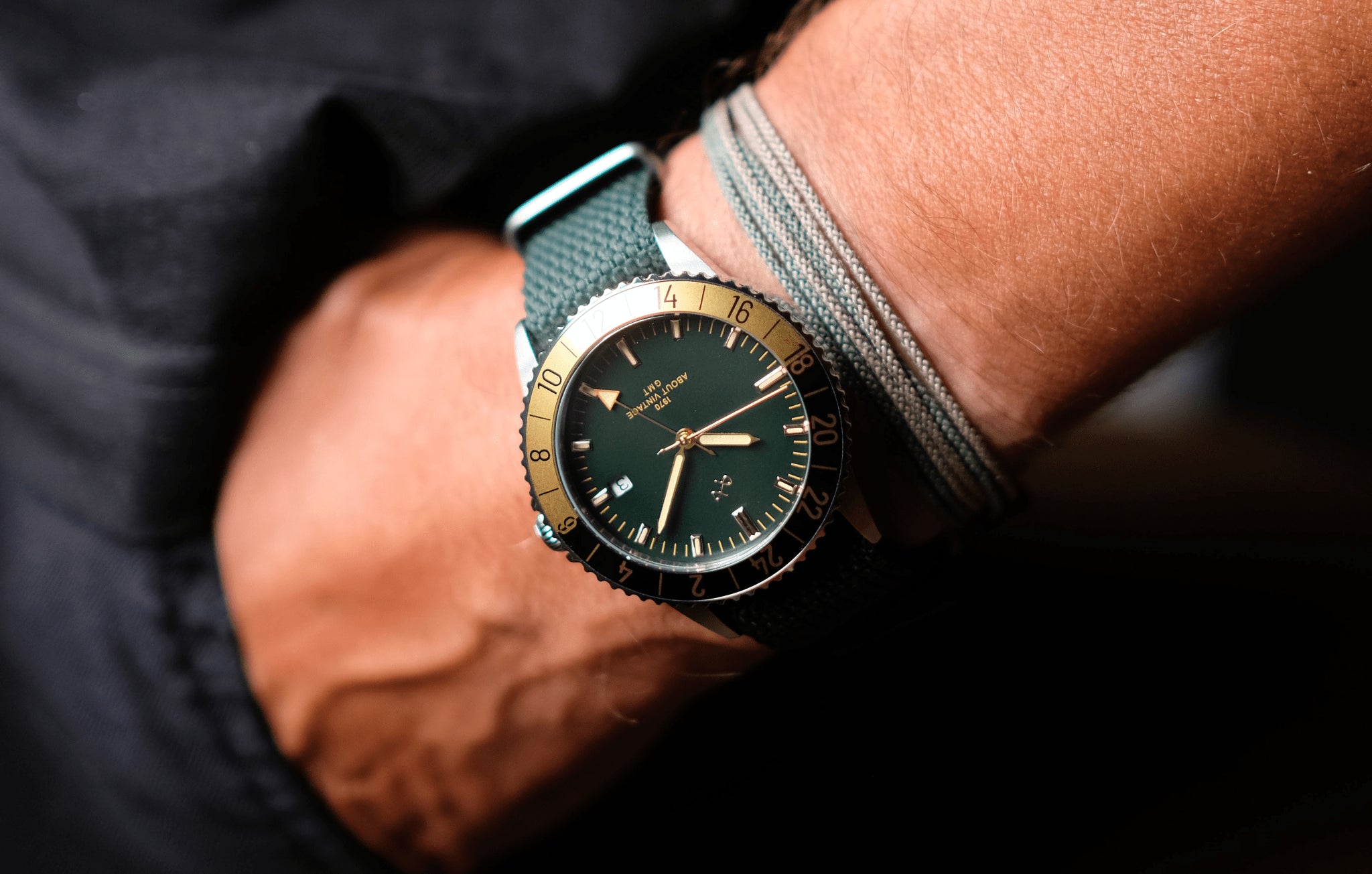 1970 Haagen GMT Automatic by AV86 with vintage-inspired dial, compass bezel, sapphire crystal, and textured fabric strap on wrist