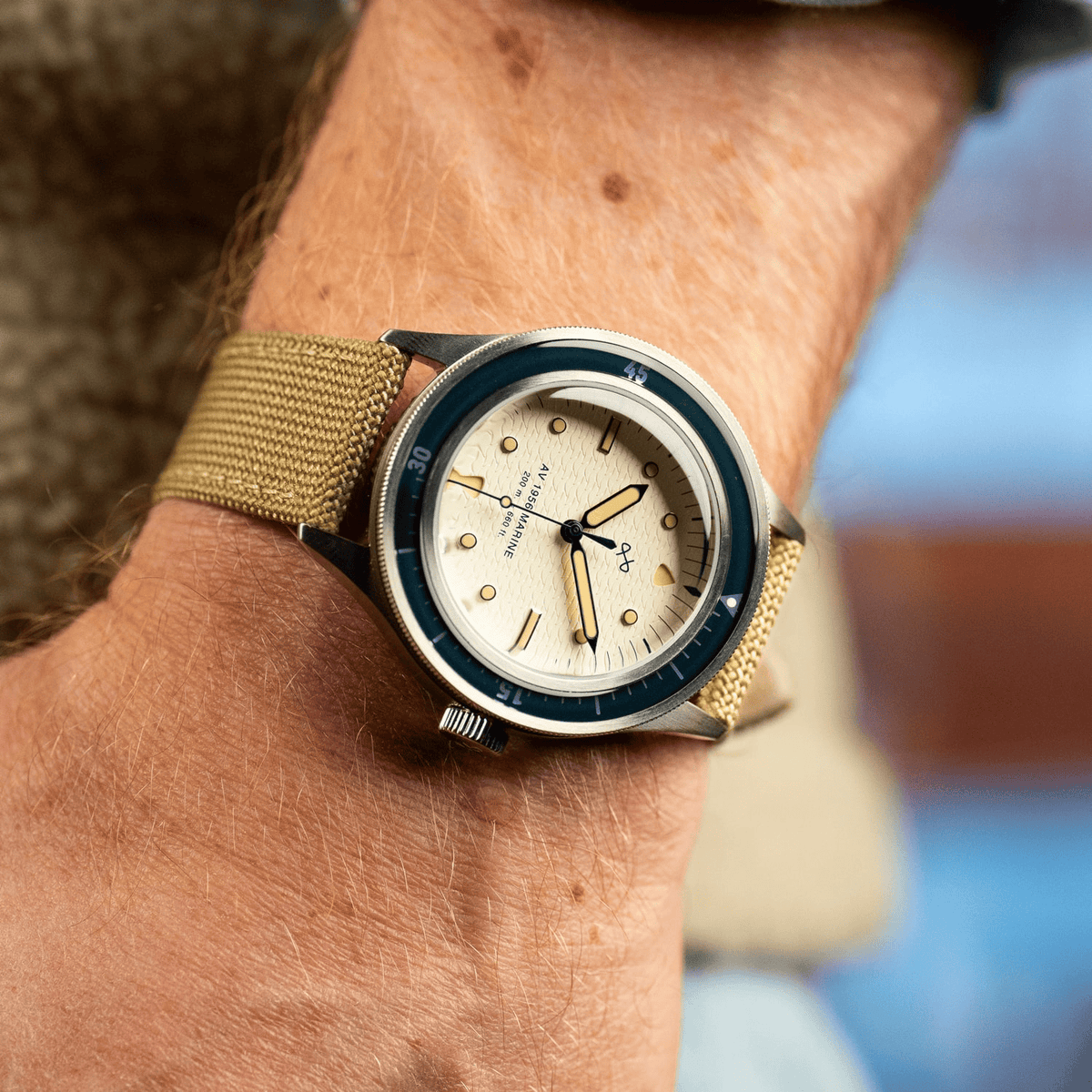 1956 Marine by AV86 vintage-inspired diver with acrylic bezel, luminous markers, textured dial, and woven fabric strap on wrist