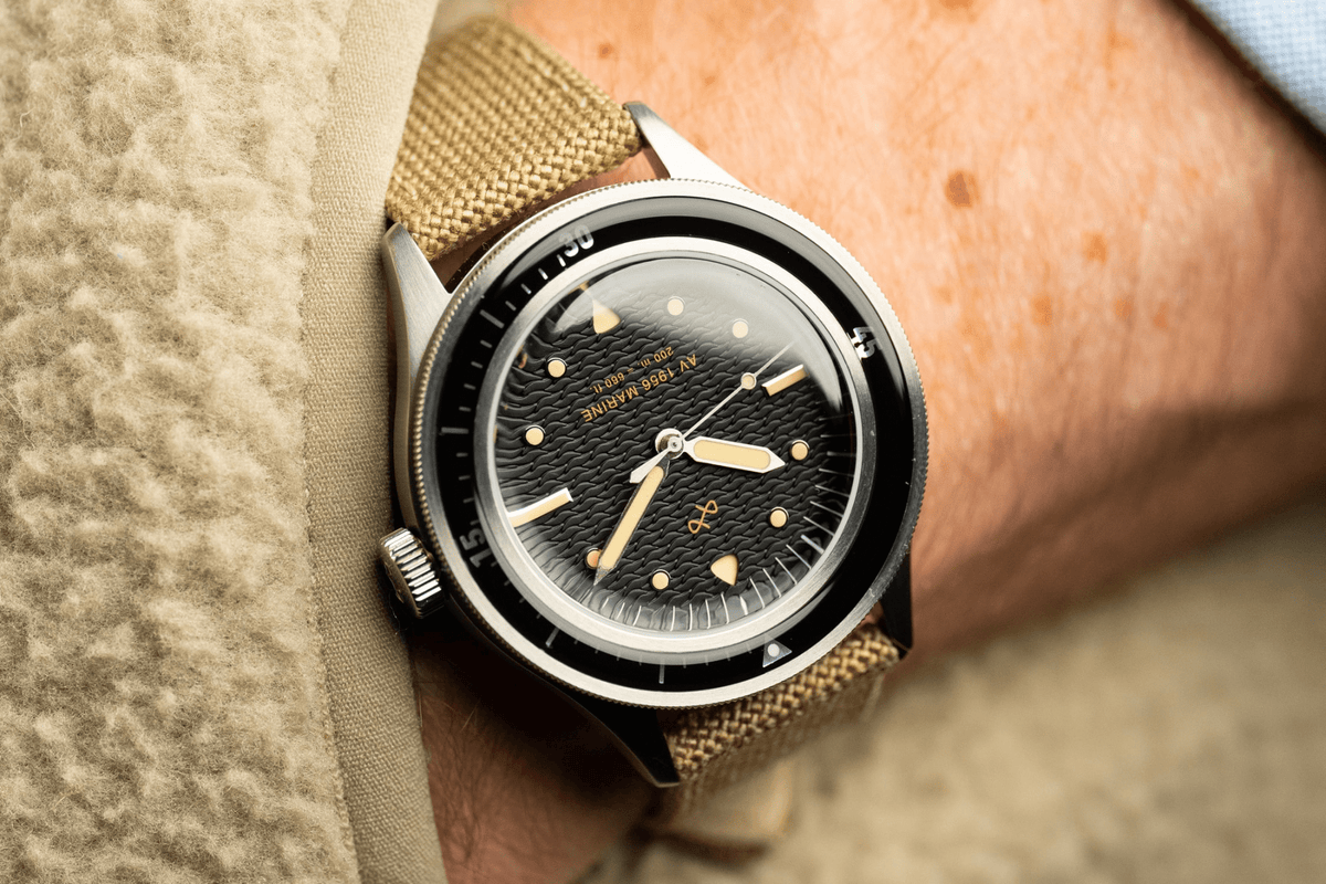 1956 Marine by AV86 vintage-inspired diver with acrylic bezel, big luminous markers, and beige fabric strap