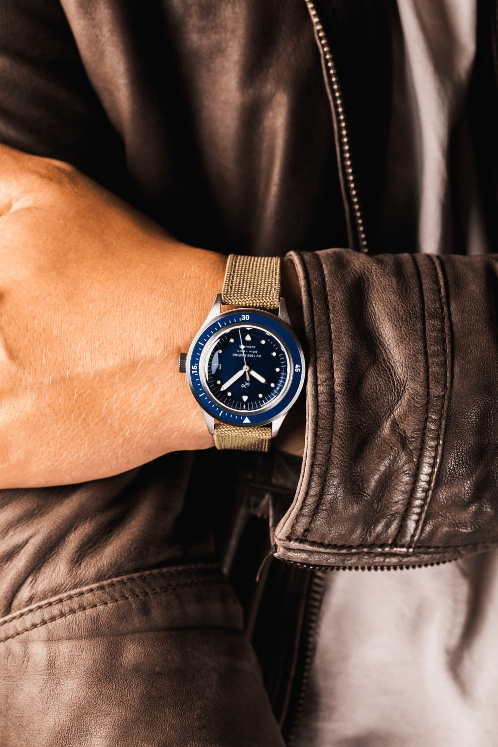 1956 Marine Automatic by AV86 vintage-inspired diver with sapphire crystal, compass bezel, and textured fabric strap on wrist