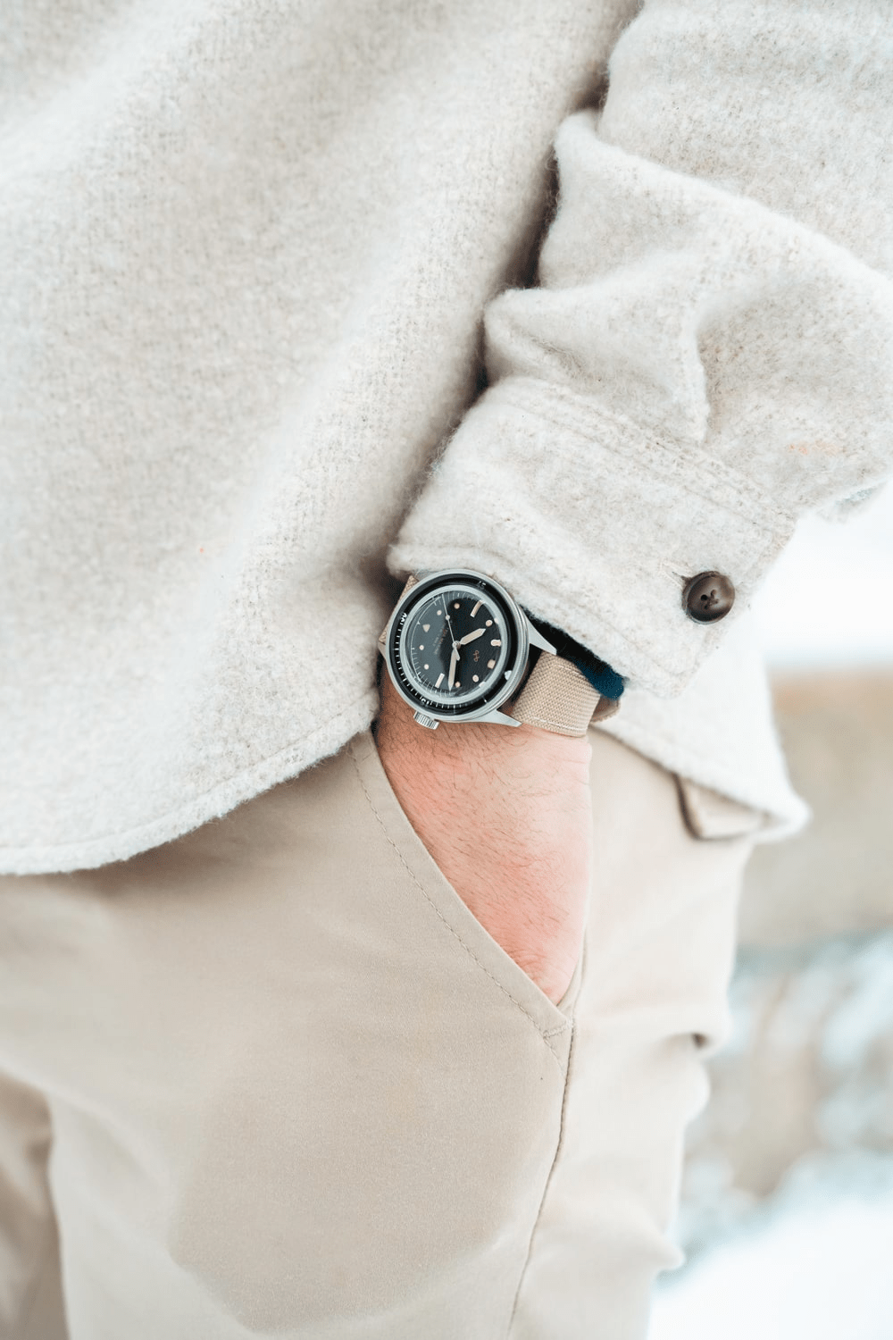 1956 Marine by AV86 vintage-inspired diver with acrylic bezel, luminous markers, and beige fabric strap in casual attire setting
