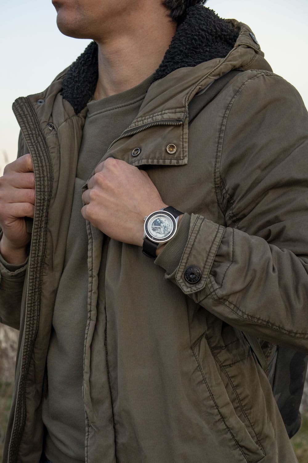 Earthrise WWF Partnership, Automatic / 2025 Edition by AV86 with Earth-inspired dial, sapphire crystal, and black leather strap on wrist outdoors