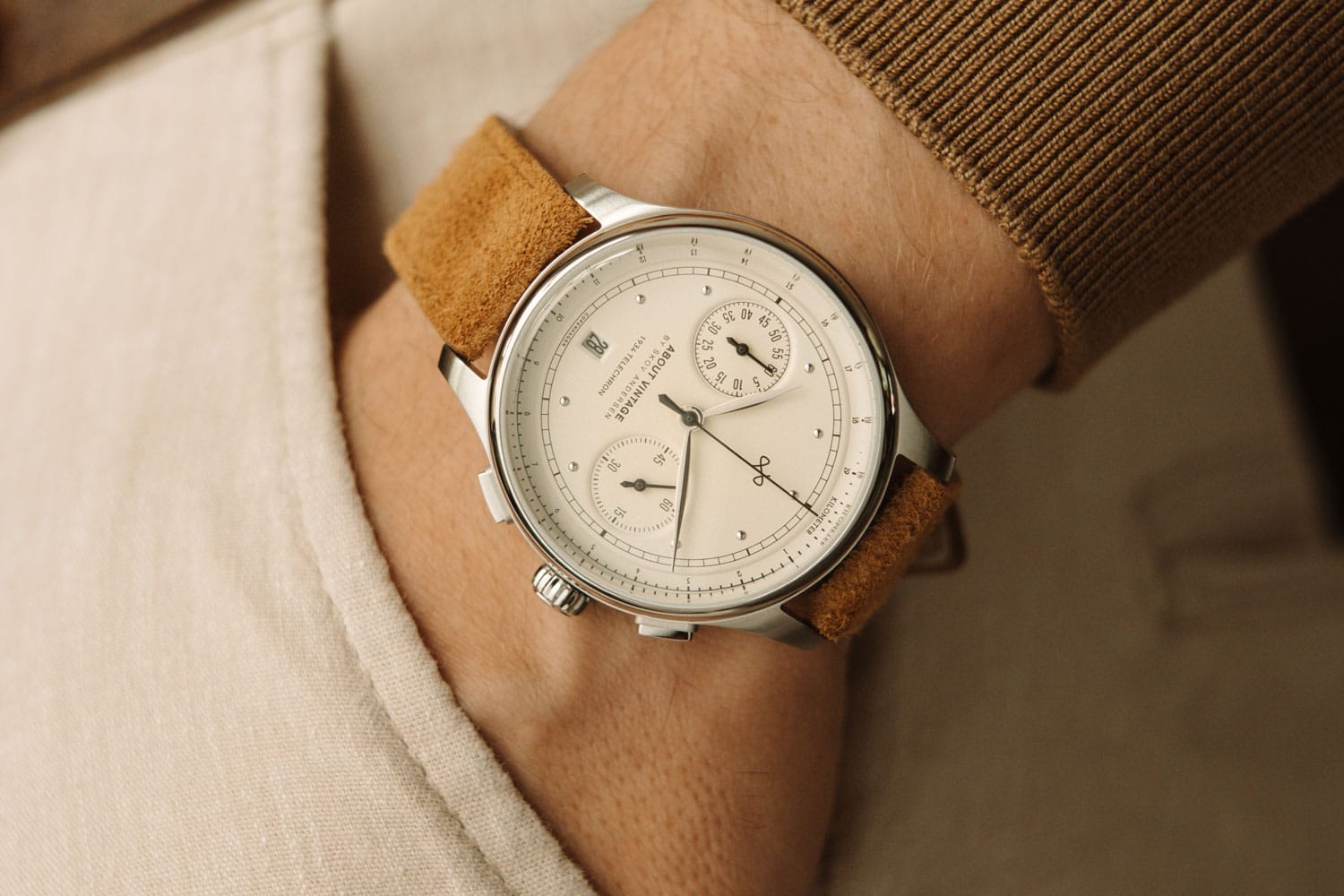 AV86 vintage-inspired chronograph with sapphire crystal, dual subdials, and textured brown suede leather strap on wrist