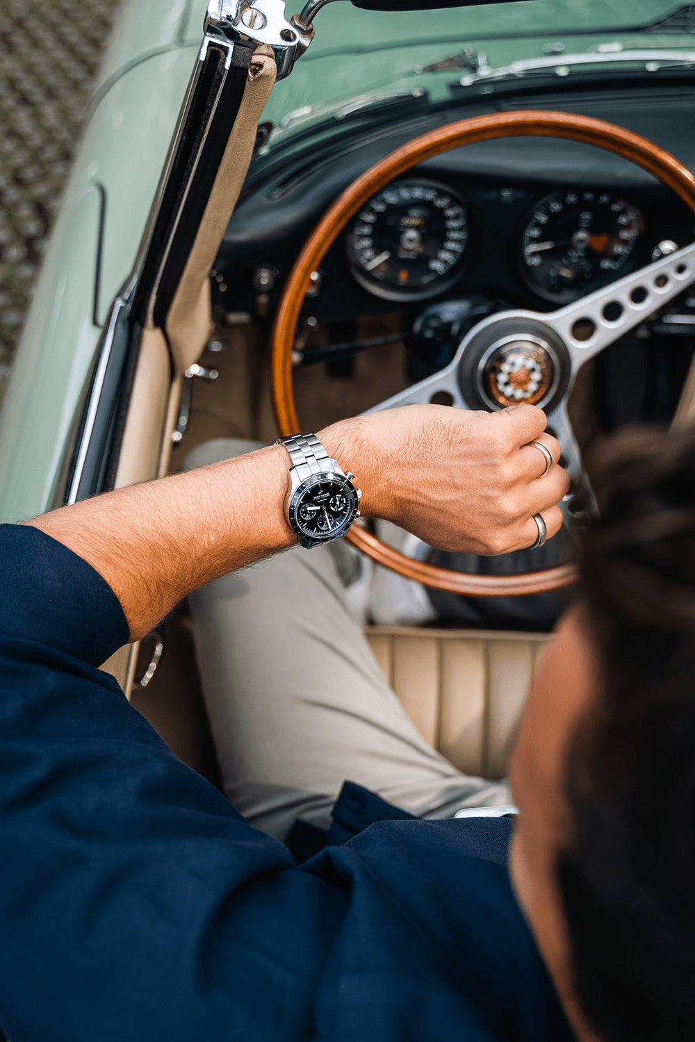 1960 Racing Chronograph by AV86 with sapphire crystal, vintage-inspired dial, steel bracelet, worn in classic car setting