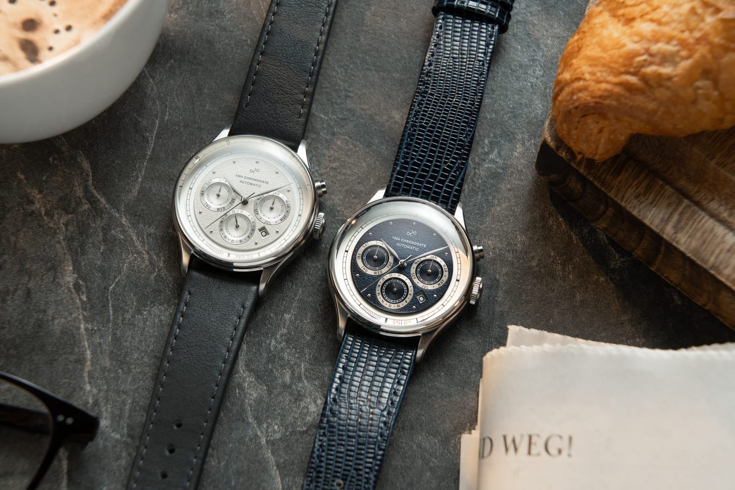 1564 Chronodate Automatic, Steel / White by AV86 presents a vintage-inspired automatic chronograph with a white dial featuring three subdials, polished stainless steel case, sapphire crystal, and a black leather strap, embodying refined Danish design and Nordic minimalism.