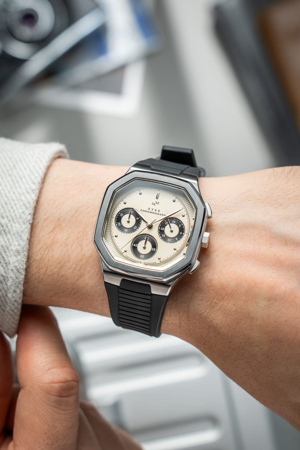 1904 Chronograph by AV86 with angular case, sapphire crystal, chronograph subdials, and black rubber strap on wrist