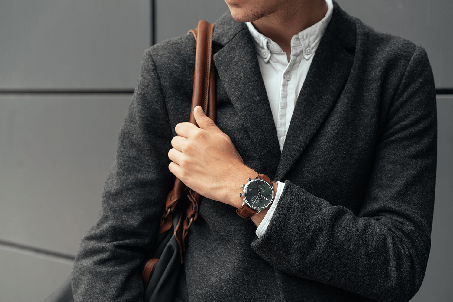 1815 Chronograph by AV86 with vintage-inspired dial, sapphire crystal, chronograph function, and brown leather strap on wrist in urban attire