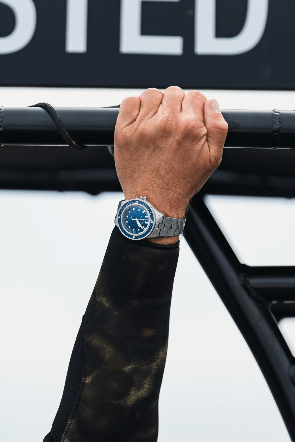 1956 Marine Automatic by AV86 vintage-inspired diver with sapphire crystal, compass bezel, and metal bracelet strap worn in active setting