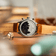 1844 Chronograph by AV86 showcasing engraved case back, polished steel, and genuine leather strap in a warm ambient setting