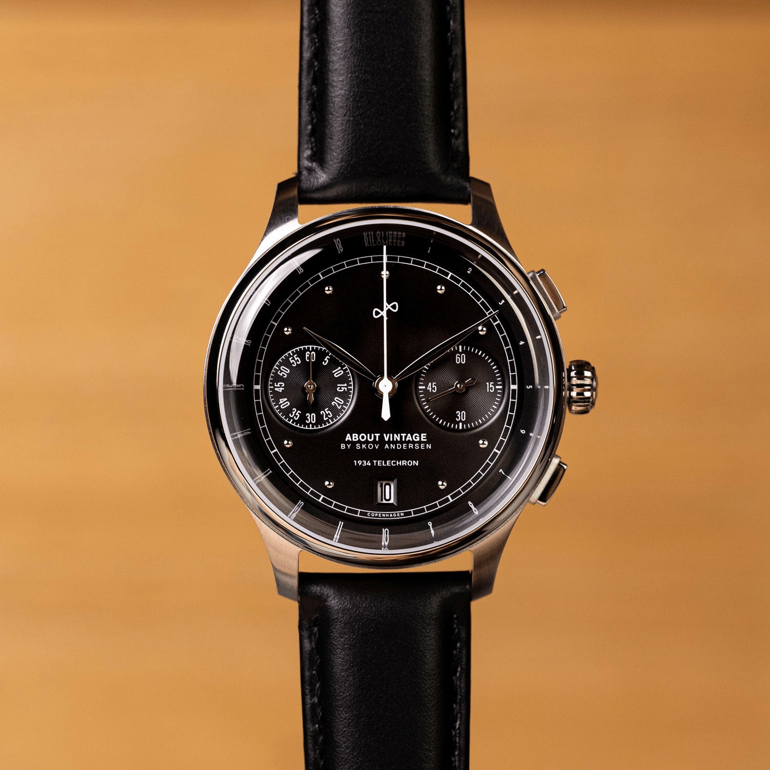 1934 Telechron, a luxury chronograph by AV86 with a black dial, dual subdials, date window, polished steel case, sapphire crystal, and black leather strap, embodying Scandinavian horological excellence and minimalist design.