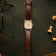 1954 Amalfi Mechanical, Steel / Off White vintage-inspired watch by AV86 with brown leather strap on dark surface with chess pieces