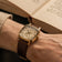 1954 Amalfi Mechanical by AV86 with polished cushion case, vintage off-white dial, small seconds, and textured leather strap worn reading book