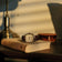 1954 Amalfi Mechanical by AV86 on vintage book with warm light, highlighting cushion case and leather strap in classic setting