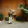 Man wearing 1954 Amalfi Mechanical, Steel / Off White watch by AV86 in a courtyard with plants and rustic wall background