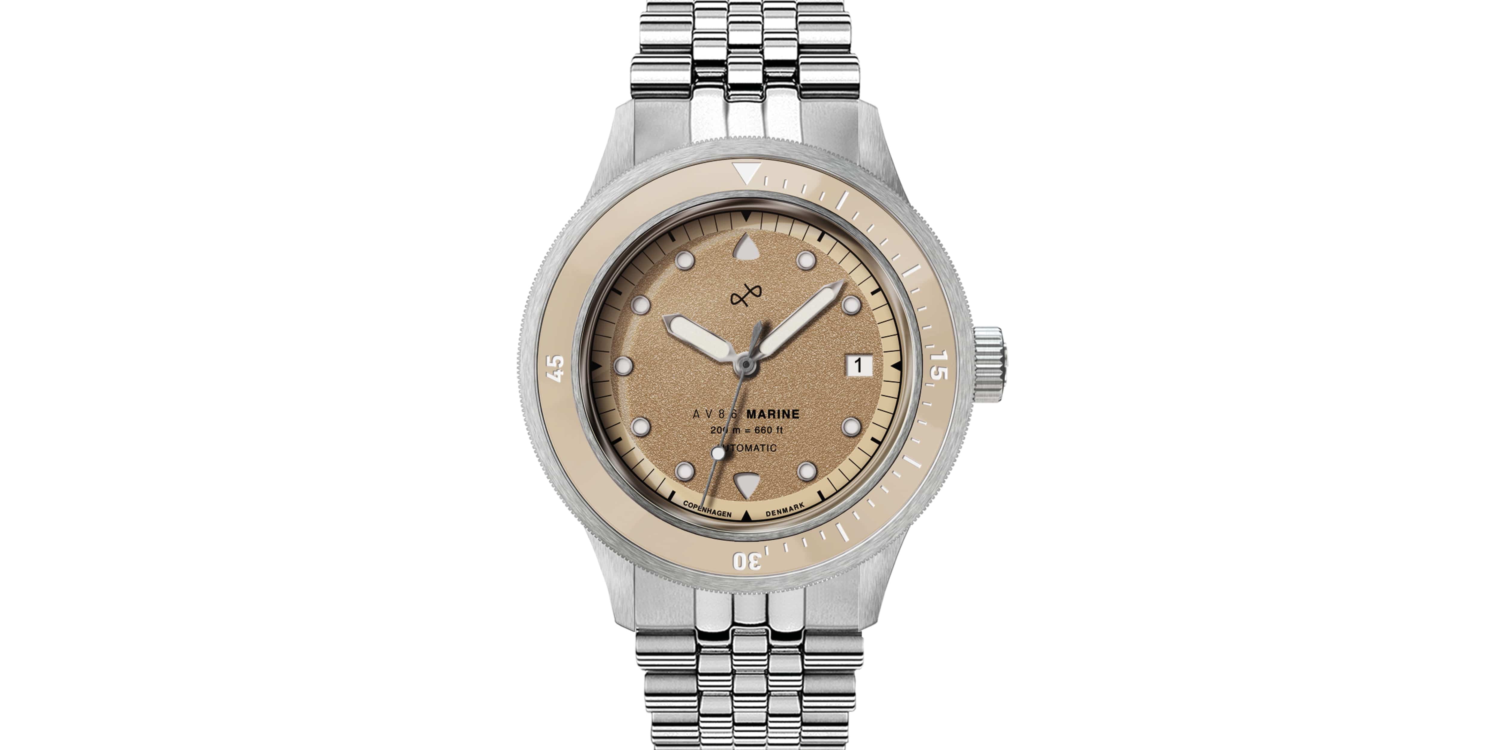 Stainless steel wristwatch with a sand-colored dial, matching bezel, and linked metal bracelet on a white background.