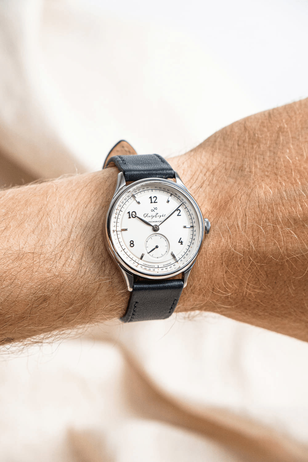 1968 Mechanical by AV86 vintage-inspired automatic watch with sapphire crystal, minimal dial, and black leather strap on wrist