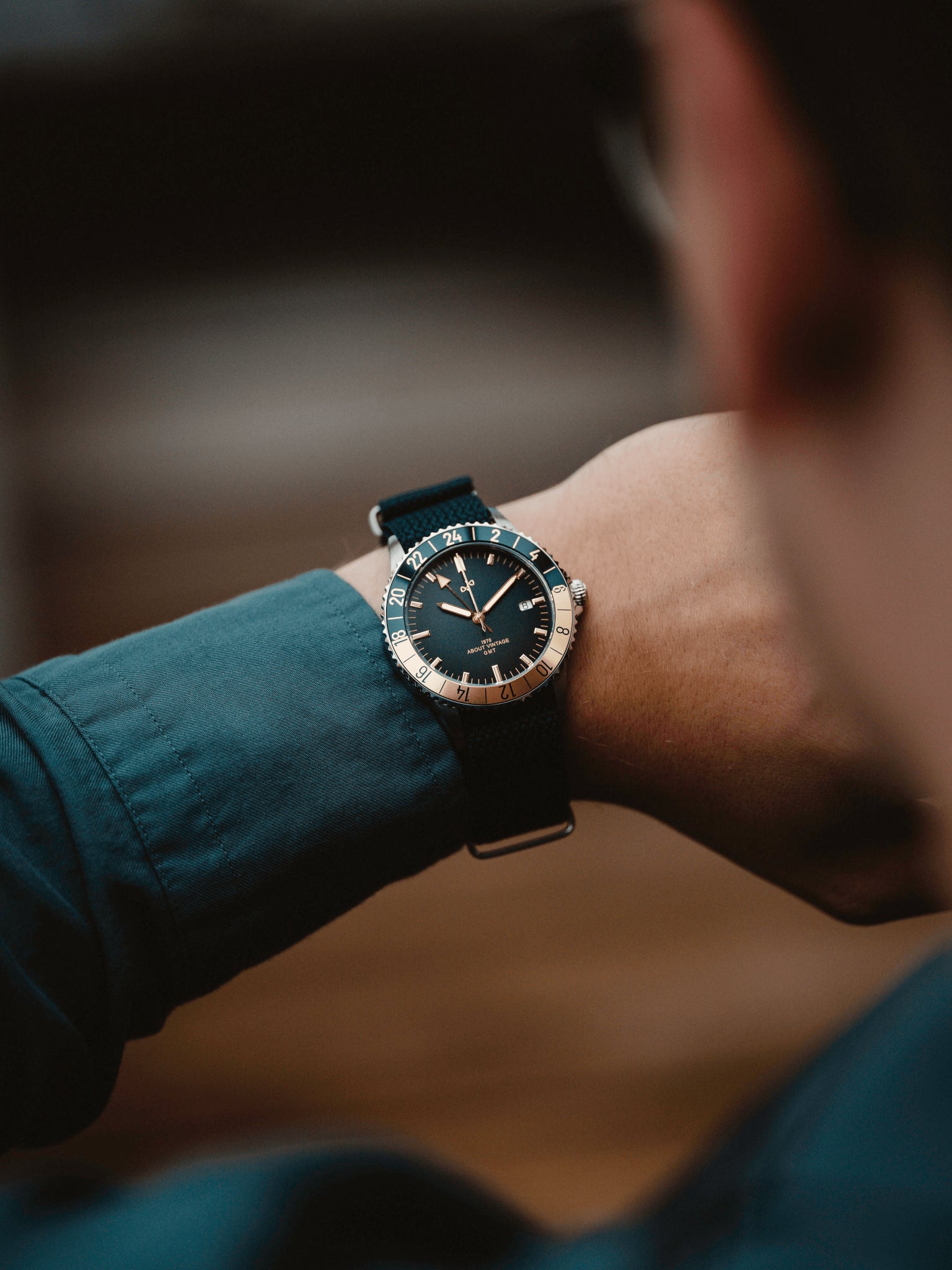 1970 Haagen GMT Automatic by AV86 with vintage-inspired dial, sapphire crystal, GMT bezel, and textured fabric strap on wrist