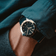 1970 Haagen GMT Automatic by AV86 with vintage-inspired dial, sapphire crystal, compass bezel, and textured fabric strap on wrist