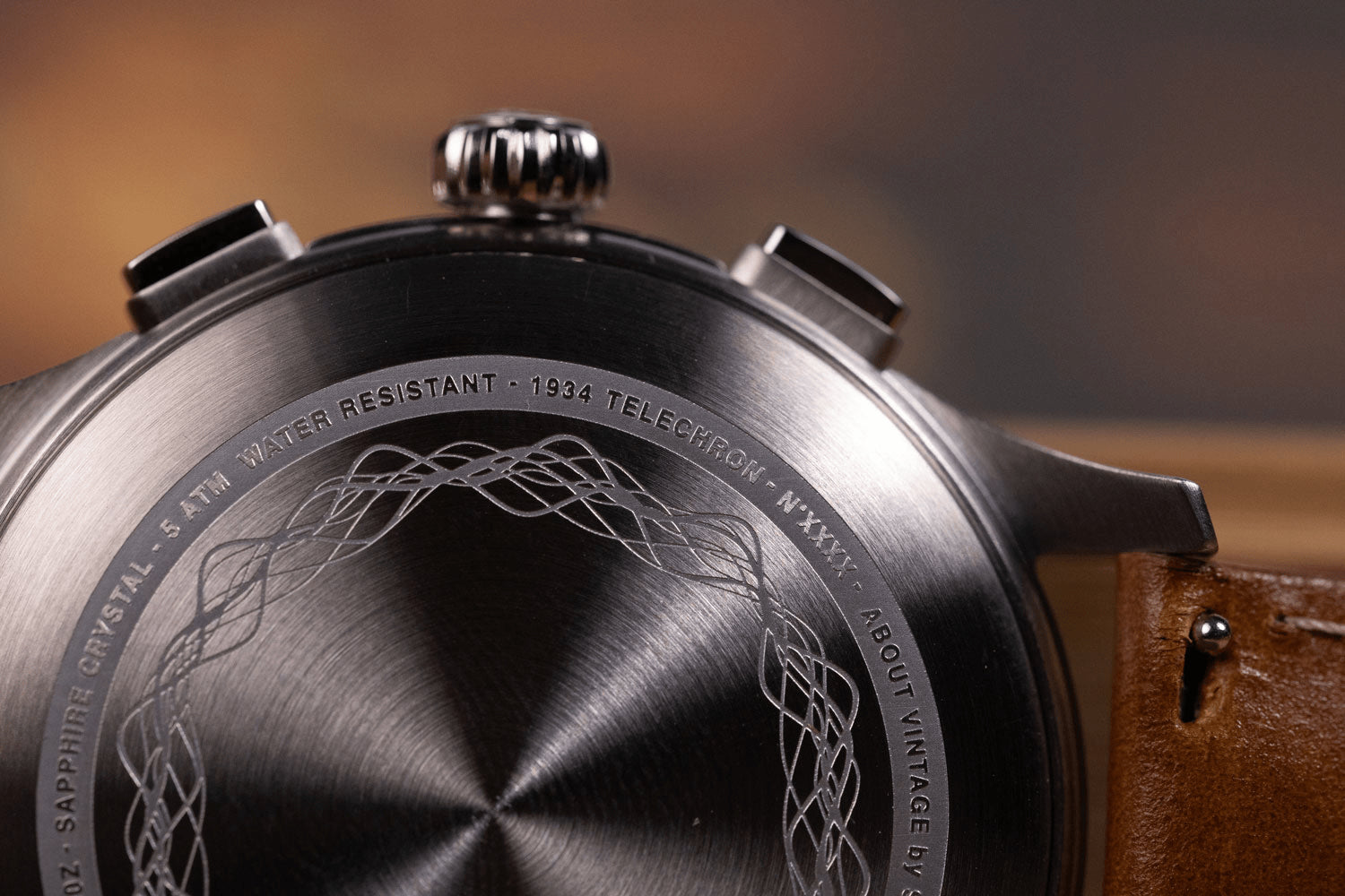 Close-up of the brushed caseback of the 1934 Telechron by AV86, featuring engraved vintage-inspired detailing and a brown leather strap, highlighting craftsmanship and Scandinavian design.