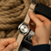 1956 Marine by AV86 showing stainless steel case back and natural leather strap in warm ambient setting with nautical rope background