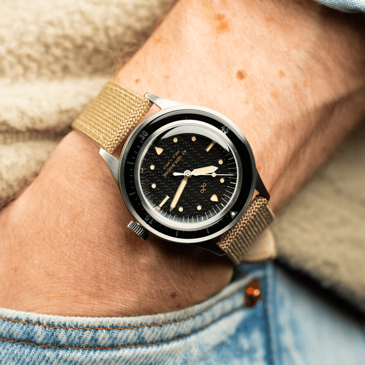 1956 Marine by AV86 vintage-inspired diver with acrylic bezel, textured dial, luminous markers, and beige fabric strap