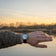 Earthrise WWF Partnership, Automatic / 2025 Edition by AV86 with automatic movement, sapphire crystal, and black rubber strap outdoors at sunset