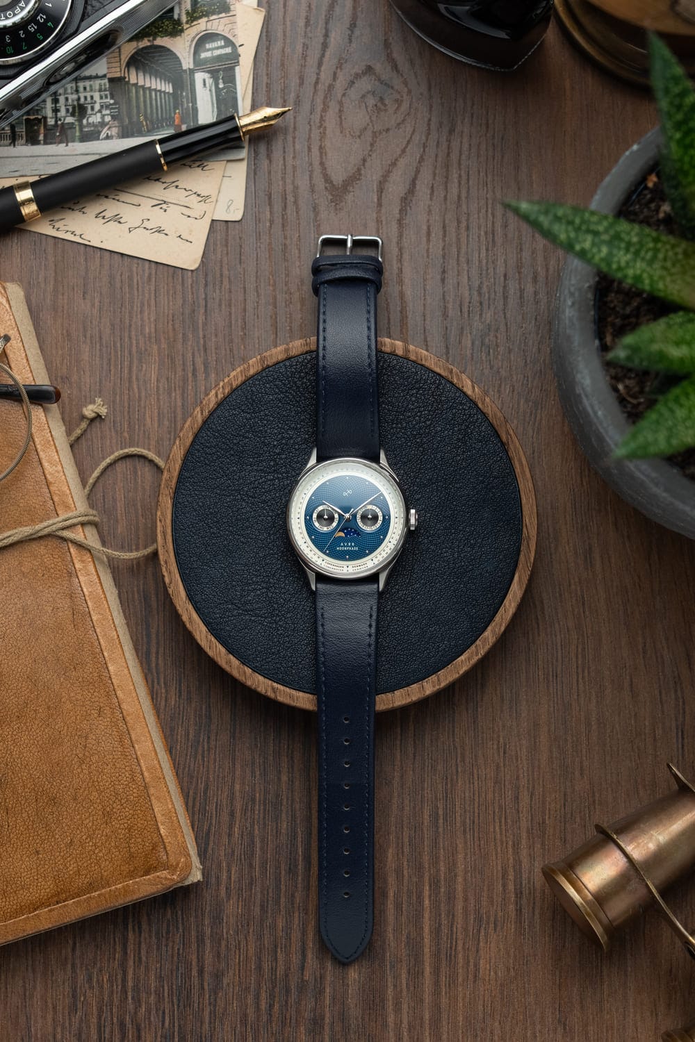 1968 Moonphase by AV86 luxury moonphase watch with sapphire crystal, vintage-inspired dial, and dark leather strap on wood surface