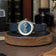 1968 Moonphase by AV86 luxury moonphase watch with sapphire crystal, vintage-inspired dial, and dark leather strap on wooden stand