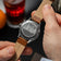 1564 Chronodate Automatic by AV86 with engraved case back, automatic movement, and brown genuine leather strap