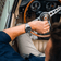 1960 Racing Chronograph by AV86 with sapphire crystal, vintage-inspired dial, steel bracelet, worn in classic car setting