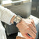 1904 Chronograph by AV86 angular case with sapphire crystal, chronograph dial, and black textured rubber strap on wrist in travel setting
