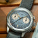 1934 Multichron, Steel / Sky Blue by AV86 featuring a vintage-inspired chronograph with a sapphire crystal, detailed tachymeter scale, and textured leather strap resting on a wooden surface.