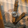 1956 Marine by AV86 vintage-inspired diver with sapphire crystal, compass bezel, and textured fabric strap on newspaper backdrop