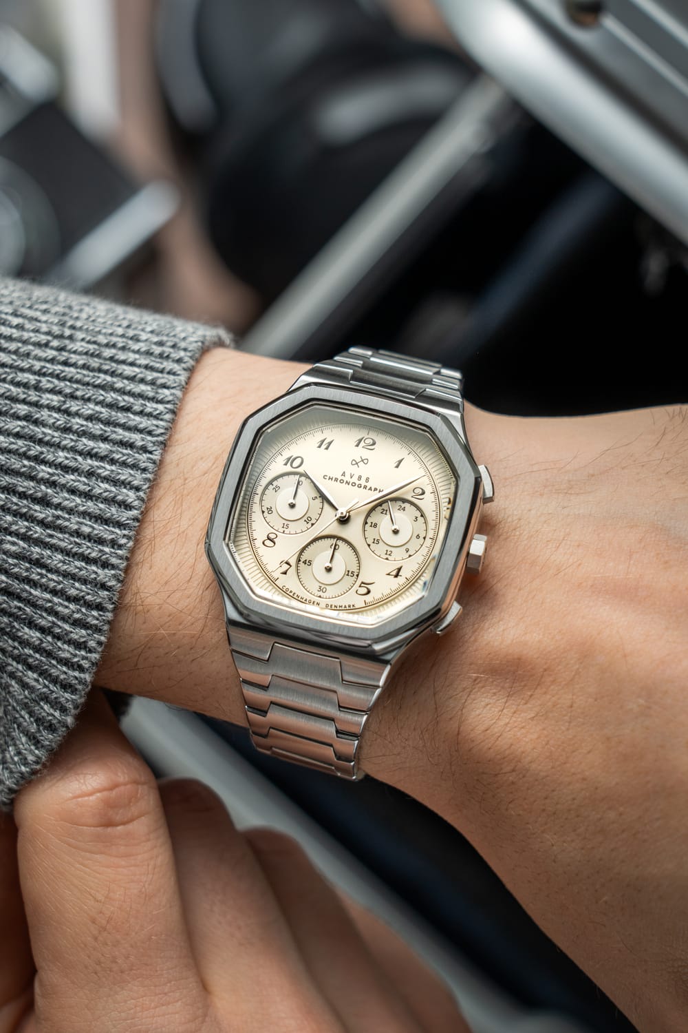 1904 Chronograph by AV86 with angular case, sapphire crystal, chronograph dial, and brushed metal bracelet strap on wrist