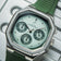 1904 Chronograph by AV86 with angular case, sapphire crystal, chronograph dial, and textured green rubber strap in minimalist style