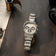 1904 Chrono with a brushed steel case and bracelet, featuring three chronograph subdials and a sapphire crystal, styled with vintage camera gear for a Nordic minimalist aesthetic by AV86.