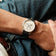 1564 Chronodate Automatic by AV86 features a vintage-inspired chronograph with a white dial, triple subdials, polished case, sapphire crystal, and black leather strap, worn casually with denim for a relaxed yet refined look embodying Danish design and Nordic minimalism.