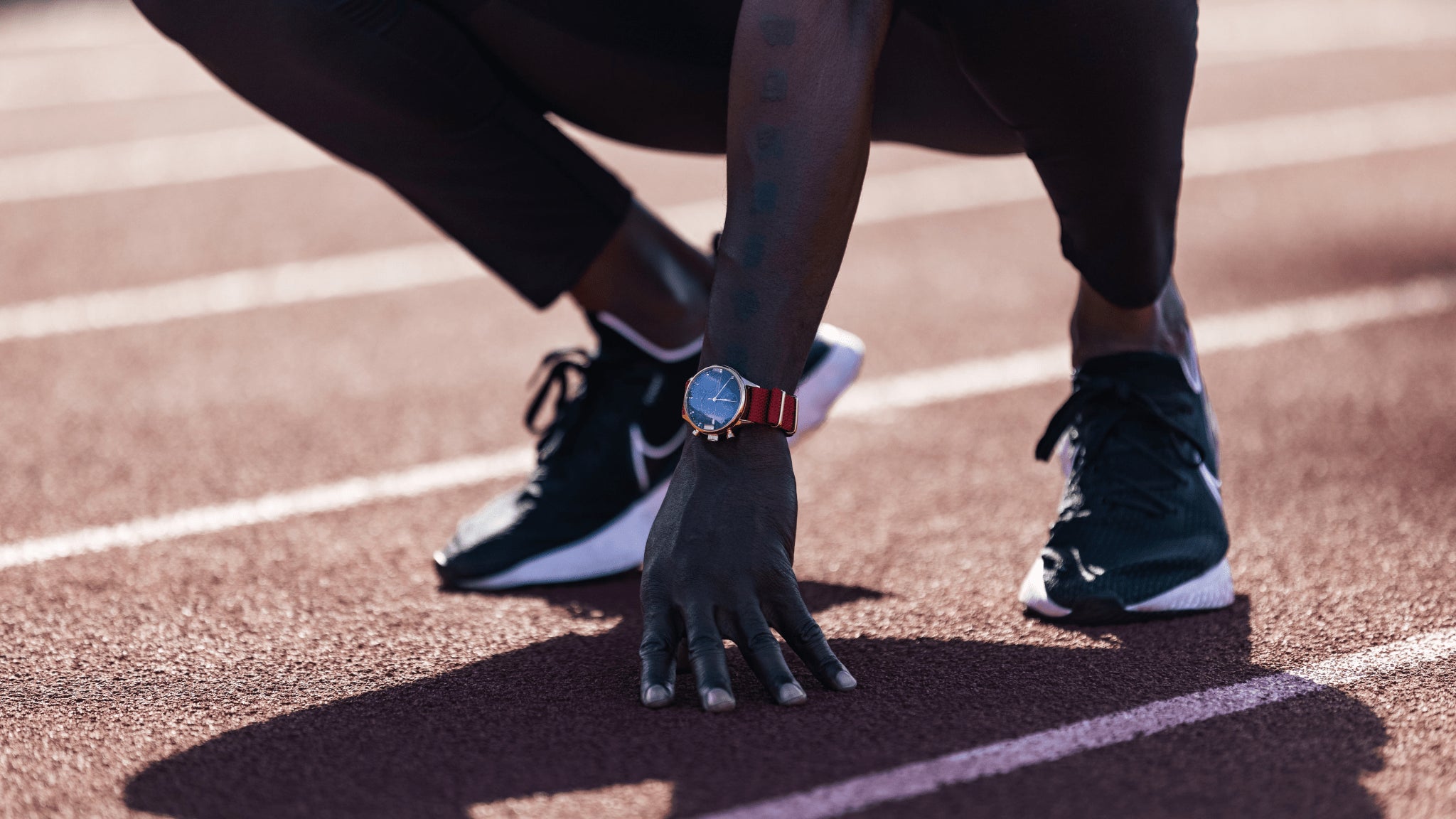 1815 Justin Gatlin by AV86 vintage-inspired chronograph with sapphire crystal and red fabric strap on sprinter’s wrist
