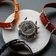 1815 Justin Gatlin, Gold / Blue Turtle by AV86 chronograph case back alongside interchangeable fabric NATO straps in orange, red, and blue