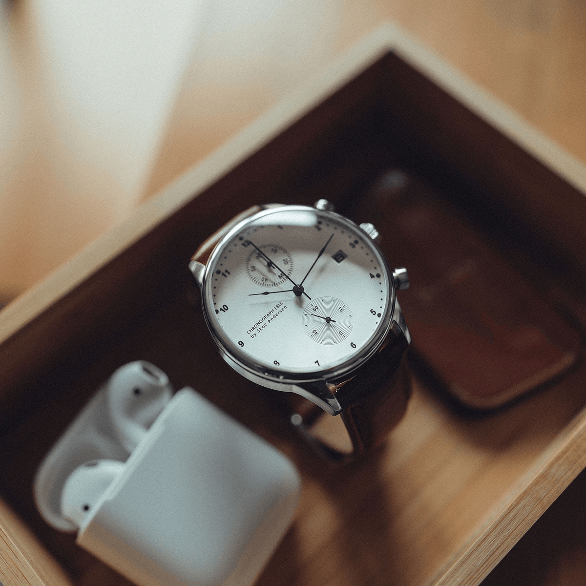 1815 Chronograph by AV86 luxury vintage-inspired chronograph with sapphire crystal, classic dial, and brown leather strap in wooden tray