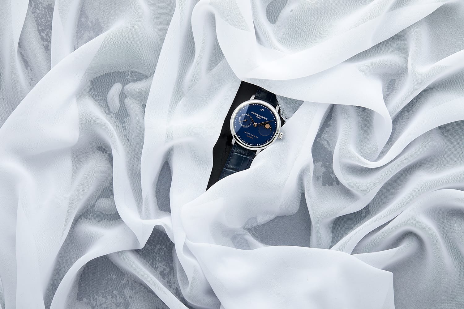 1988 Moonphase, Limited Edition by AV86 luxury automatic moonphase with sapphire crystal and leather strap on sheer fabric backdrop
